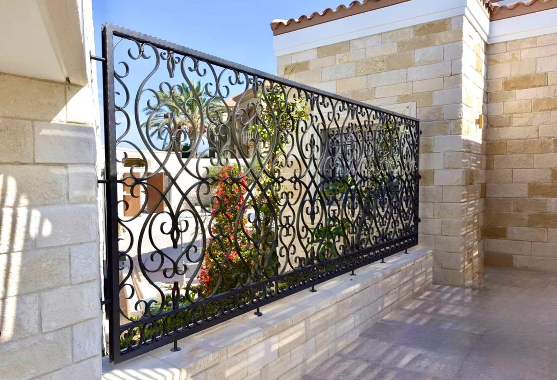 Decorative handmade metal railing by Artifex outside a Mediterranean home