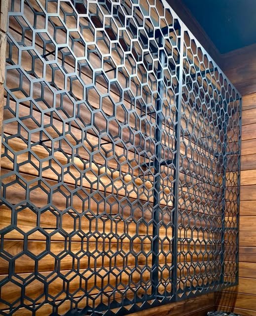 Geometric honeycomb metal partition with a warm interior behind it