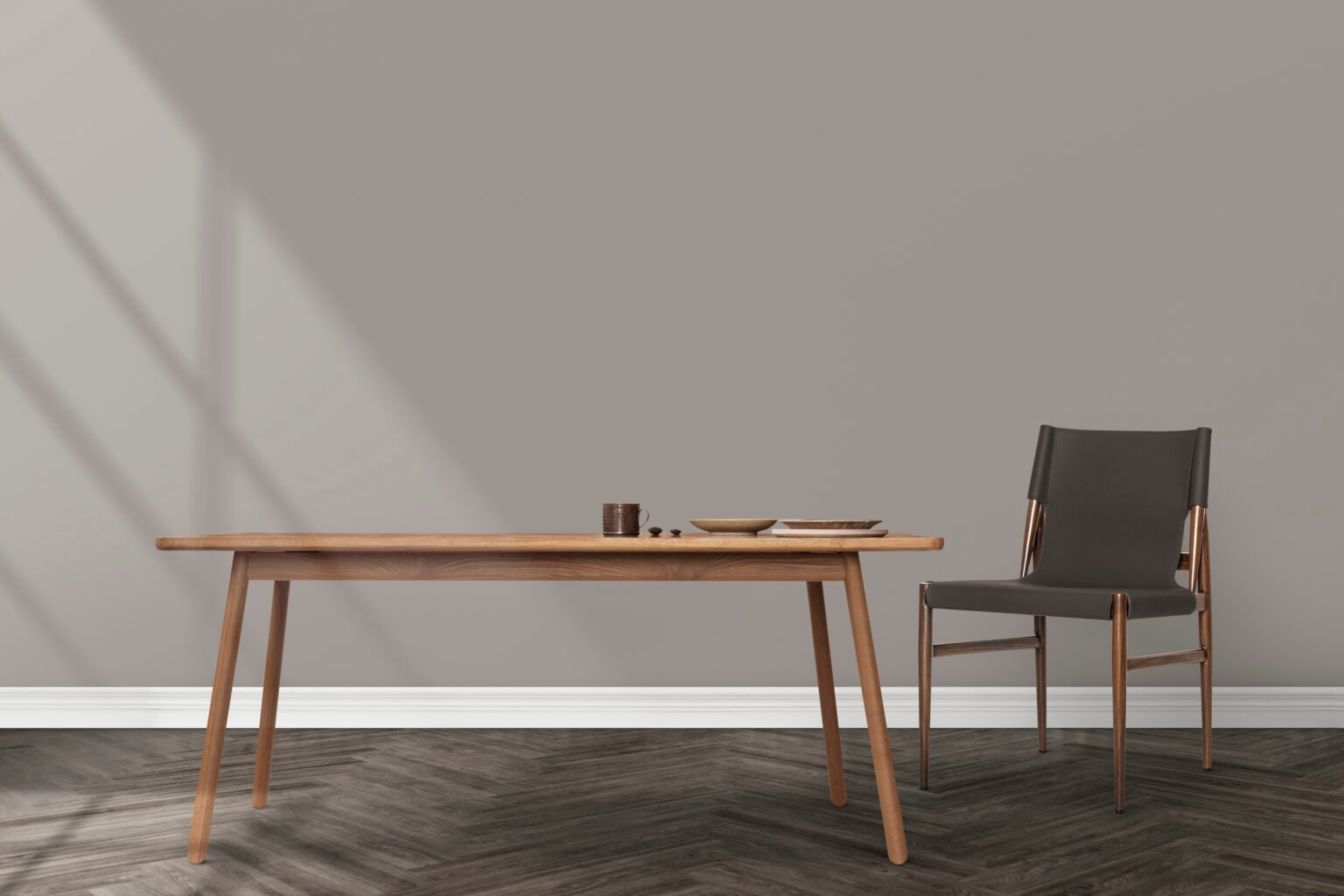 Slender wooden dining table and dark upholstered chair in a minimal interior